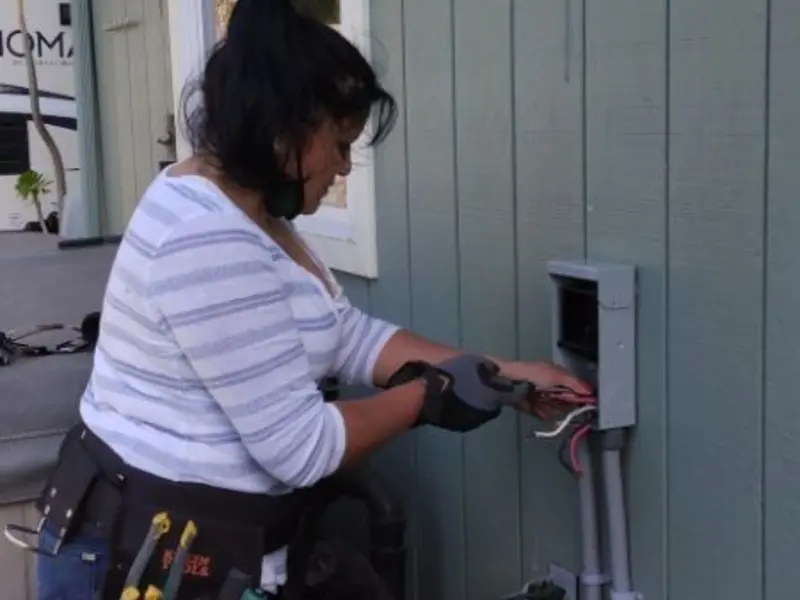 Licensed electrician wiring an exterior subpanel in Whitehall